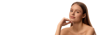 Banner. Woman resting chin on hand, showing calm confidence, smooth skin and fresh natural glow, posing against white background. Copy space. Concept of purity, self-care, beauty, natural productsの写真素材