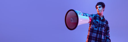 Banner. Boy holds megaphone stretched forward with serious expression, looking up with pride, in neon light against gradient background. Concept of leadership, confidence, determination, curiosityの写真素材