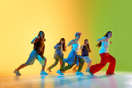 Youthful dancers showcase vibrant moves in a colorful urban setting, expressing creativity and energy. Concept of modern dance culture in city environments.の写真素材