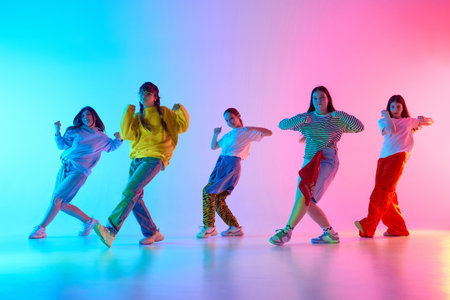 Youthful dancers express creativity and unity in a vibrant urban choreography performance,...