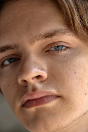 Skin-realism. Close-up of a mans skin, visible pores, light stubble, shine on the forehead. Concept...