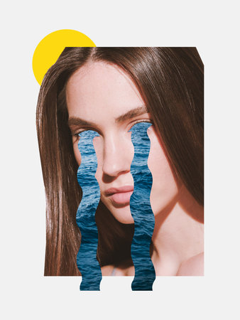 Close-up of a woman with serious expression, ocean-shaped cutouts flowing from her eyes, with a bright yellow sun shape behind her. Concept of hidden emotions beneath a composed surfaceの写真素材