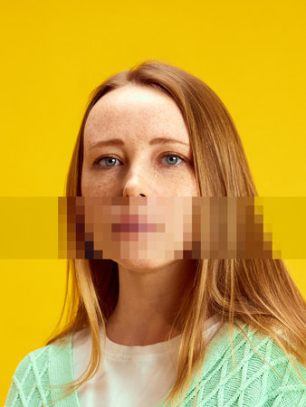 Graphic composition. Portrait of sad woman with yellow background and pixelated mouth area. Concept of censorship, silencing, digital identity, emotion suppression, and communication.の写真素材