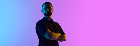 Man standing confidently with vibrant pink and blue lighting. Banner. Concept of confident fintech branding, cross-platform digital finance marketing, and leadership in crypto innovation.の写真素材