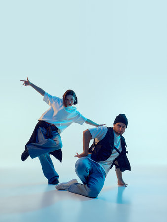 Hip-hop dancers posing in dynamic floor-level movement with dramatic focus. Concept of dance...