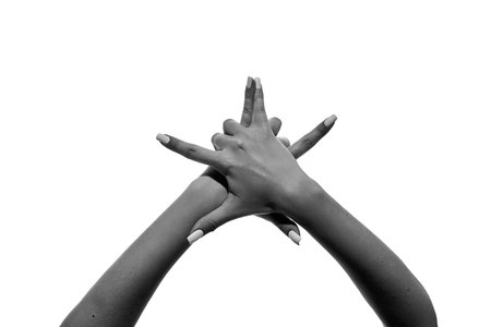 Two hands intertwined with fingers extended upward isolated on white.
