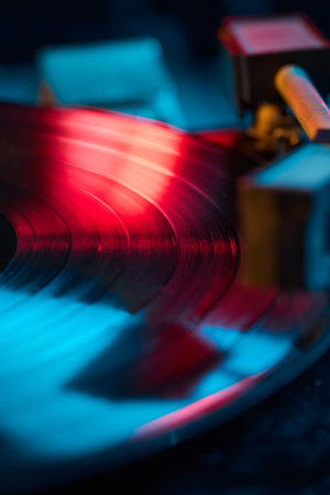 Vibrant vinyl record macro with glowing light reflection. Concept of music nostalgia, retro lifestyle, audio gear advertising, streaming visuals, and digital cover designs.の写真素材