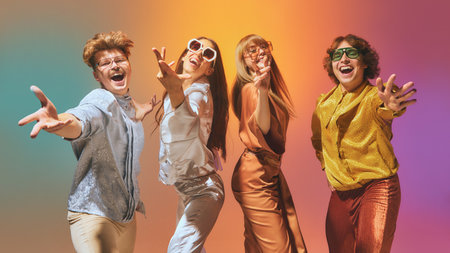Vintage styled group of four dancing in disco light with expressive retro outfits. Concept of retro fashion moodboards, cultural nostalgia, disco lifestyle, and glam event branding.の写真素材