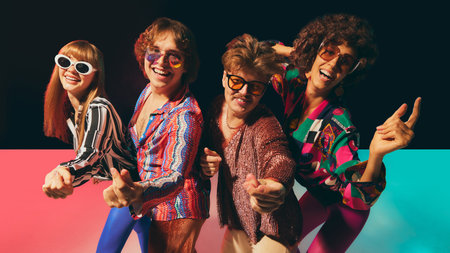 Retro disco friends laughing together in vibrant vintage costumes. Concept of pop culture nostalgia, lifestyle marketing, fun fashion branding, and funky cultural advertising.の写真素材