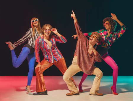 Retro group posing in disco dance formation with playful gestures. Concept of vintage fashion, pop culture nostalgia, party lifestyle and joyful retro identity.の写真素材