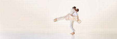 Ballet dancers embrace in airborne pose with flowing fabric, capturing graceful lines and suspended...