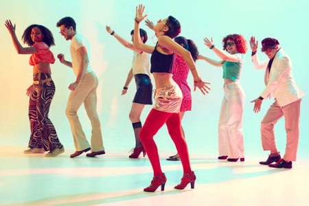 Retro styled group dancing with joyful energy under colorful lights. Concept of music promo, youth...