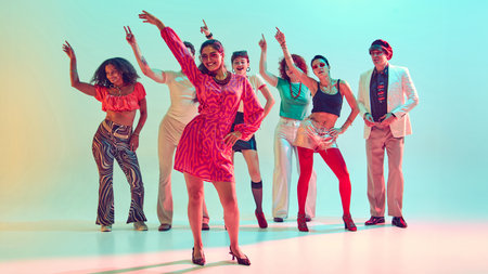 Smiling woman leading dance group with confidence in vibrant studio. Concept of leadership, cultural...