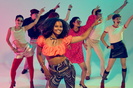 Woman in red crop top leading group dance with smiles and retro style. Concept of leadership in...