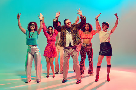 Group of stylish dancers raising hands in retro disco atmosphere. Concept of youth celebration,...