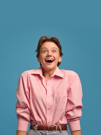 Surprised happy woman smiling with raised eyebrows expressing amazement. Concept of curiosity,...