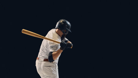 Baseball batter lowering bat before swing showing pre-impact shoulder control. Concept of...