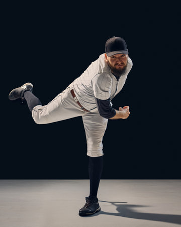 Baseball pitcher finishing throw showing full-body balance and technique. Concept of pitching mechanics, sports education, and fitness marketing visuals.の写真素材