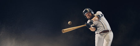 Baseball batter hitting ball midair with dust in the air showing perfect timing and precision. Concept of kinetic accuracy, focus, sports performance for coaching, education.の写真素材