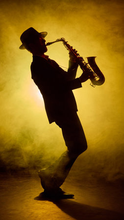 Jazz saxophonist performing on stage with artistic smoke lighting. Concept of music industry campaigns, and editorial features on urban culture.の写真素材