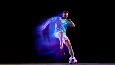 Soccer player leaping for powerful header with neon light motion. Concept of passion, precision, and strength used in sports campaigns, teamwork visuals, and modern athletic branding.の写真素材