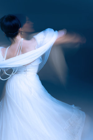 Dancer back in soft blue light, pearls tracing fluid choreography lines. Concept of beauty, luxury, decor photography, and emotional motion aesthetics.の写真素材