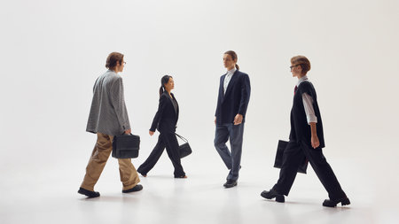 Stylish business professionals walking toward each other symbolizing connection and cooperation. Concept of partnership, unity, and collaboration in modern workplace culture.の写真素材