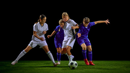 Teenage girls soccer players fighting for ball in multi-player action cluster. Concept of youth tactical training, pressure situations education, teamwork development tools.の写真素材