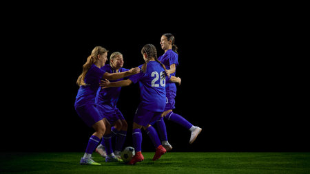 Teenage soccer team celebrating together in energetic group movement. Concept of youth club, motivation campaigns, team-spirit communication, sports promotion.の写真素材