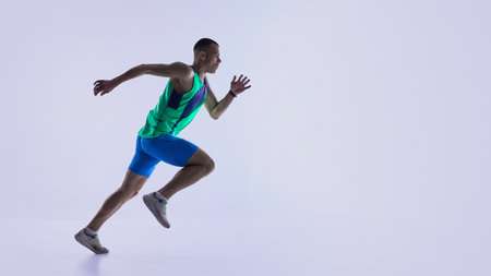 Runner pushing into powerful sprint position. Concept of coaching materials for sprint starts,...