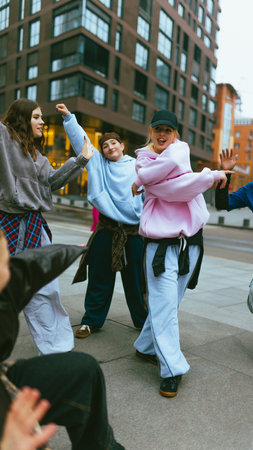 Young hip hop dancer in pink hoodie performing street routine. Concept of confident youth, dance...