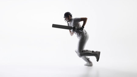 Cricket player running with bat during match action. Concept of sports performance, speed and agility training, active lifestyle promotion, athletic energy, and competitive team sports.の写真素材