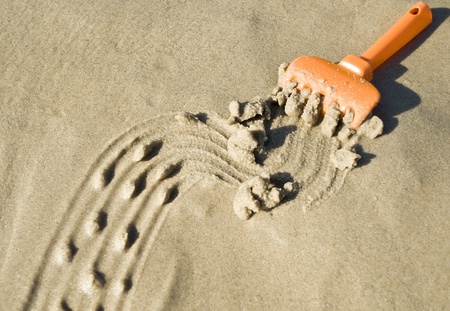 Drawing on the sand made by toy rakeの写真素材