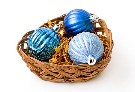 blue christmas balls in wicker vase isolated on white backgroundの写真素材