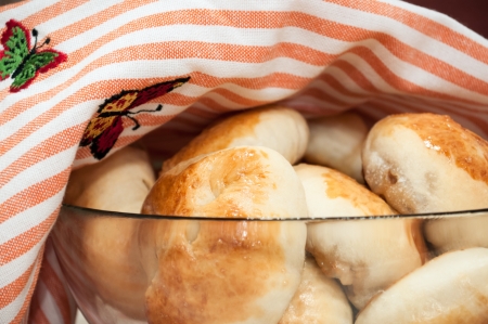 Big plate of russian pirogi covered with a towelの写真素材