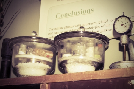Chemical glassware with chemicals on a shelf in the laboratory