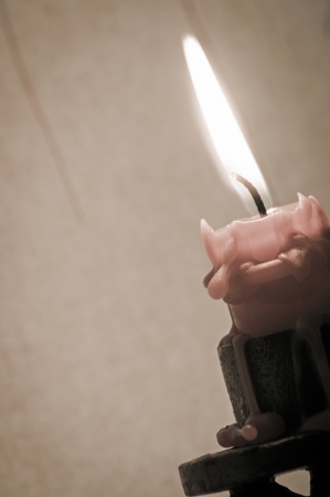 Burning candle in vintage candlestickの写真素材