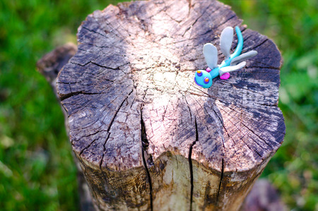 Dragonfly made of modeling clay on natural backgroundの写真素材