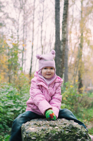 Little girl Playing in Autumn Park Leaves, Fall forestの写真素材