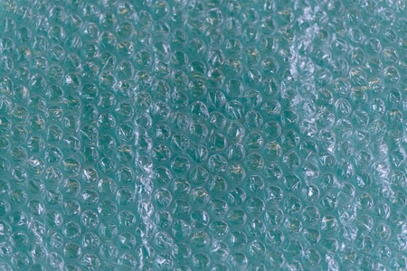 Page of Large Clear Bubbles on bubblewrap packaging material. Packaging with air bubbles - blue texture.の写真素材