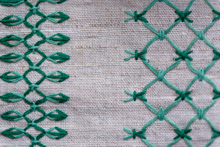 fragment of embroidered ornament on a linen napkin