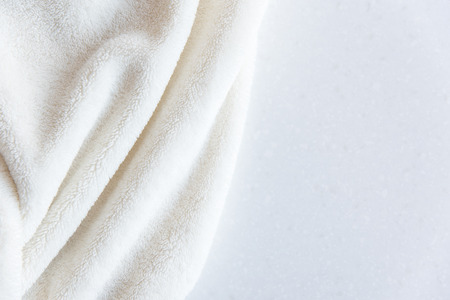 White delicate soft background of plush fabric folds on white background. Copy space. Flat lay.の写真素材