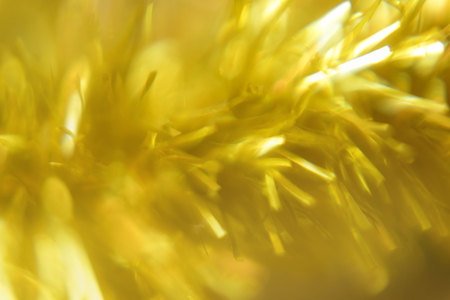 festive blurred bokeh background with glittering elements in yellowの写真素材