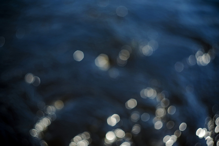 Beautiful underwater sea scene with natural light rays, shining through the water's glittering and blurred bokeh. Natural bokeh blue  blur view of water surface backgrounds. Bokeh light background in the pool.の写真素材