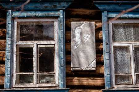 Tarusa, Kaluga region, Russia, April 19, 2019. Old collapsing wooden house in which the Russian poet Nikolai Zabolotsky lived for two summers. Rubbish, man and dog in the street in front of the house.のeditorial素材
