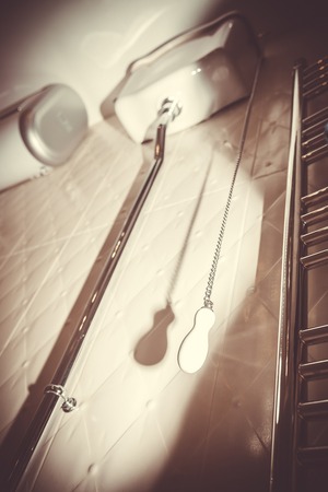 White toilet cistern of the old design. Chain with ceramic handle to drain water in the toilet....