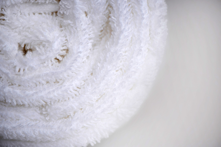 White delicate soft background of fur plush smooth fabric. Clean white towel rolled blanket textile. Concept spa.の写真素材