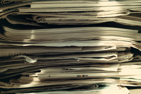 Pile of old newspapers and magazines, stack, side view. Texture from a stack of old newspapers and magazines. Vintage backgroundの写真素材