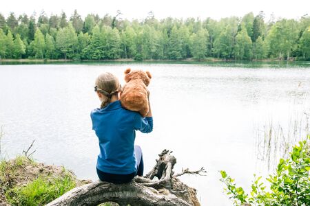 Teddy Bear is a fluffy toy for little cute girl. Every Child love Teddy Bear as their Best Friends hugging and holding together to go to Picnic. Kids on playground. Best Friend Concept.の写真素材
