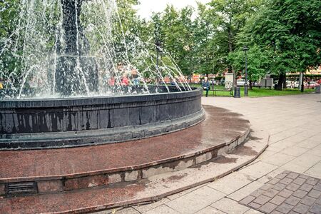 Fountain in city park on summer day. stream of water, drops and bright splashes of water in beautiful city fountain. Bright streams of sparkling water in city fountainの写真素材